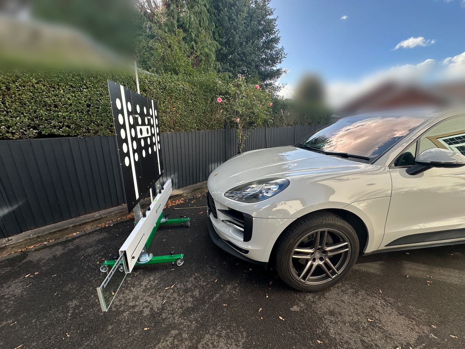 Porsche Macan on a home driveway facing a dot-pattern camera calibration target in Doncaster