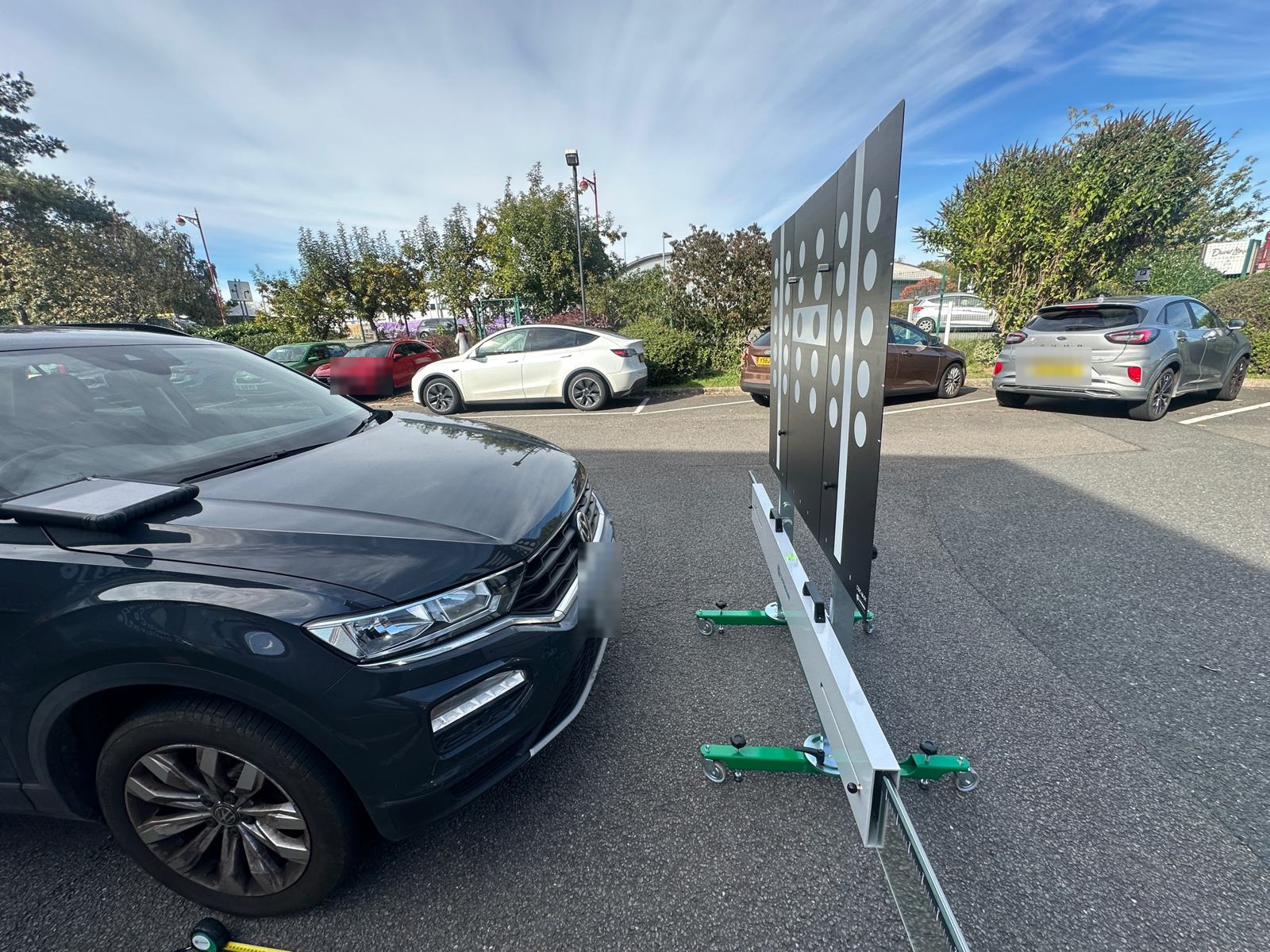 VW T-Roc in a car park facing a camera calibration target board in Derby