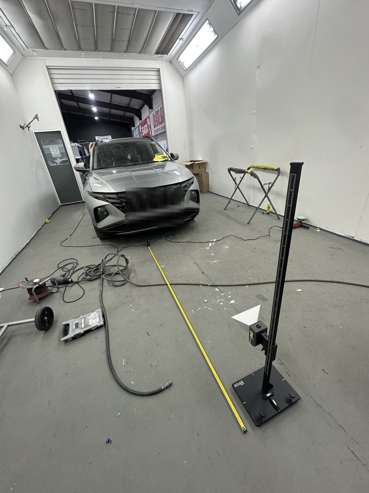 Hyundai Tucson in a bodyshop booth with a radar reflector stand measured out in front in Sheffield
